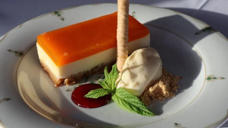 Citrus mousse dessert plated with garnish